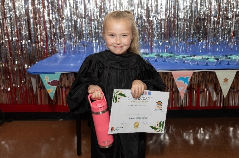 2025 Grad with her personalised drink bottle and certificate of gradaution